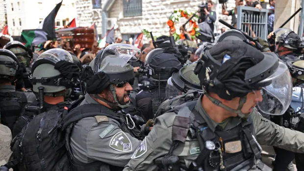 Israeli police push and hit mourners carrying slain Al Jazeera journalist's casket