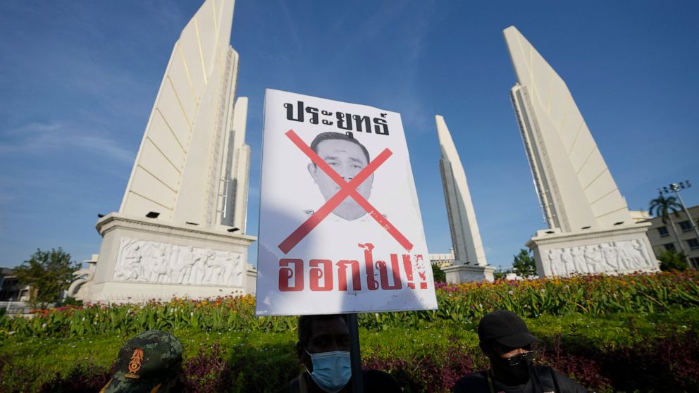 Anti-government protesters with poster which reads "Prayuth get out" gather in front of Democracy Monument in Bangkok, Thailand Tuesday, Aug. 23, 2022. Thailand’s Constitutional Court on Monday received a petition from opposition lawmakers seeking a