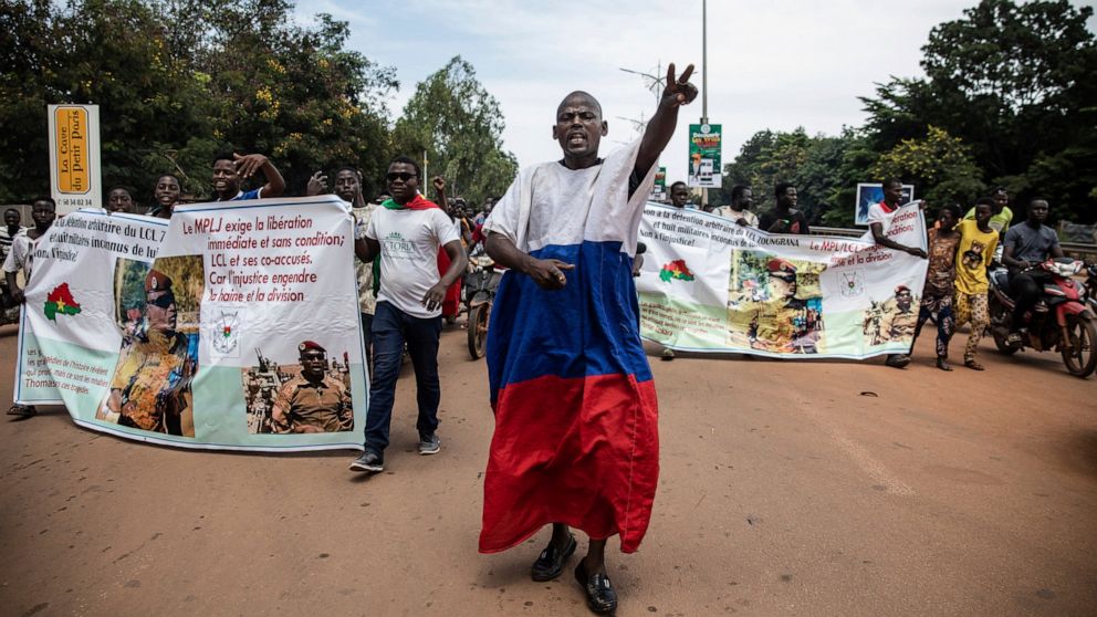 Young men chant slogans against the power of Lieutenant-Colonel Damiba, against France and pro-Russia, in Ouagadougou, Burkina Faso, Friday Sept. 30, 2022. Residents say gunfire rang out early in the morning and the state broadcaster has gone off the