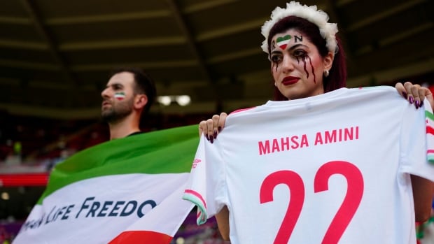 Iran government supporters, security confront protesters at World Cup