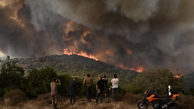 Greek firefighters continue to battle deadly wildfires as 2 more people arrested for arson